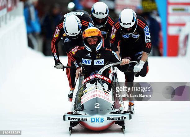 Maximilian Arndt, Marko Huebenbecker, Alexander Roediger and Martin Putze of Germany compete during the Four Men Bobsleigh heat three of the IBSF Bob...
