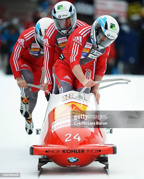 Rico Peter, Thomas Ruf, Patrick Bloechliger and Simon Friedl of Switzerland compete during the Four Men Bobsleigh heat three of the IBSF Bob &...