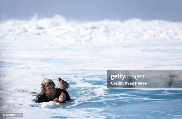 John John Florence of the United States paddles out during previews ahead of the 2023 SHISEIDO Tahiti Pro on August 07, 2023 in Teahupo'o, French...