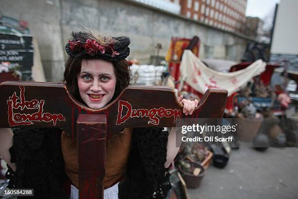 An employee of 'The London Dungeon' poses with props previously used at the attraction which are to be sold at a car boot sale in Pimlico as the...