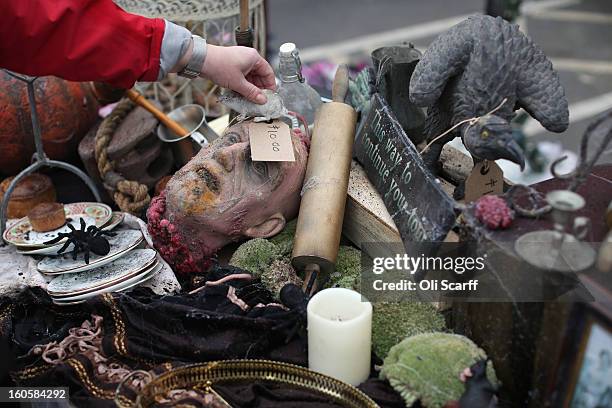 Woman arranges props previously used in 'The London Dungeon' which are to be sold at a car boot sale in Pimlico as the attraction prepares to move to...