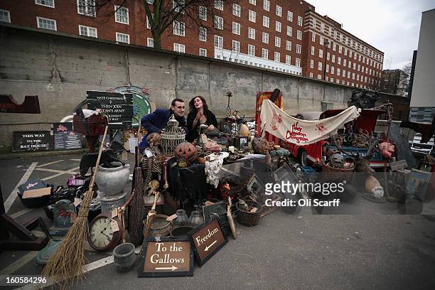 Staff stand next to props previously used in 'The London Dungeon' which are to be sold at a car boot sale in Pimlico as the attraction prepares to...