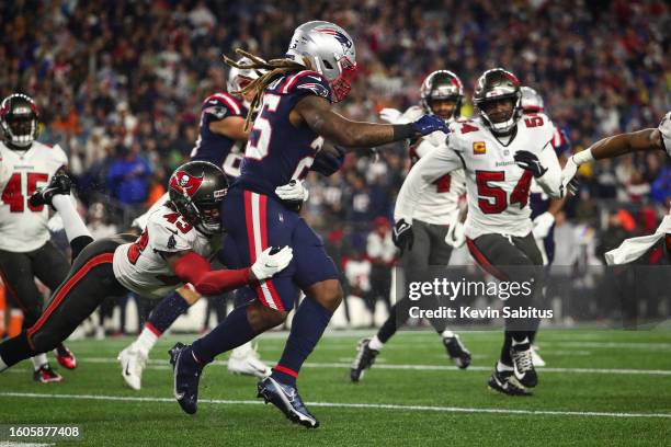 Ross Cockrell of the Tampa Bay Buccaneers tackles Brandon Bolden of the New England Patriots during an NFL game at Gillette Stadium on October 3,...