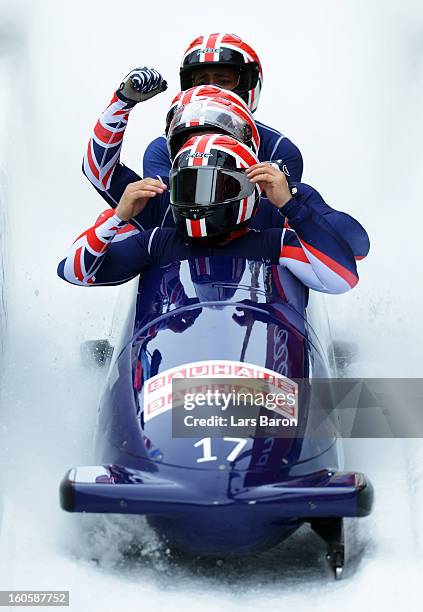 John James Jackson, Stuart Benson, Bruce Tasker and Joel Fearon of Great Britain react after the Four Men Bobsleigh final heat of the IBSF Bob &...