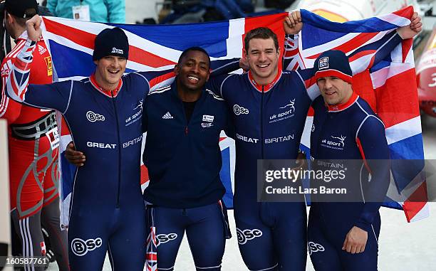 John James Jackson, Stuart Benson, Bruce Tasker and Joel Fearon of Great Britain react after the Four Men Bobsleigh final heat of the IBSF Bob &...