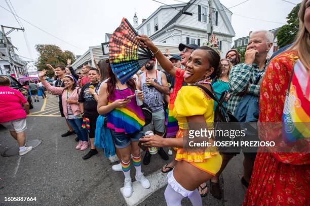 People in the street cheer on the parade marchers during the 45th Annual Provincetown Carnival Parade in Provincetown, Massachusetts, on August 17,...