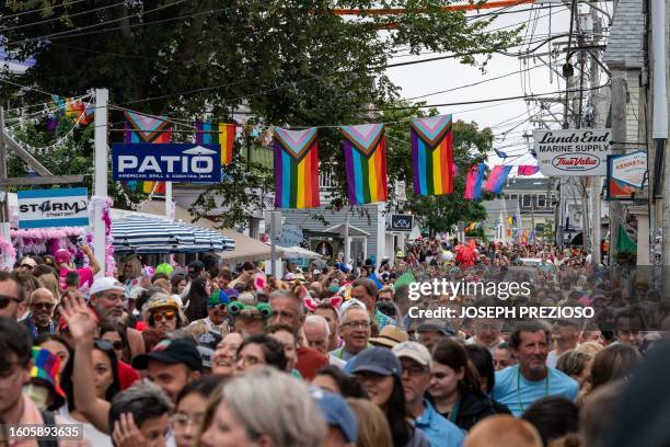 Thousands of people fill the street to see the parade during the 45th Annual Provincetown Carnival Parade in Provincetown, Massachusetts, on August...
