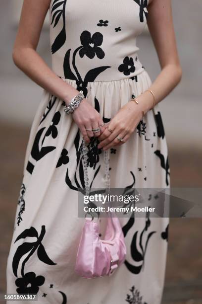 Trixi Giese seen outside Marimekko show wearing Pandora charm necklace in silver, white arm free dress with ruffled skirt part and black flower...