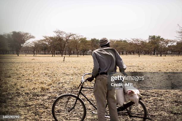 South Sudanese walks with his bicycle on the way to a new refugee camp of JanJang that is to open in March to support the already overwhelmed Yida...