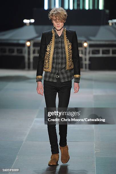 Model walks the runway at the Saint Laurent Autumn Winter 2013 fashion show during Paris Menswear Fashion Week on January 20, 2013 in Paris, France.