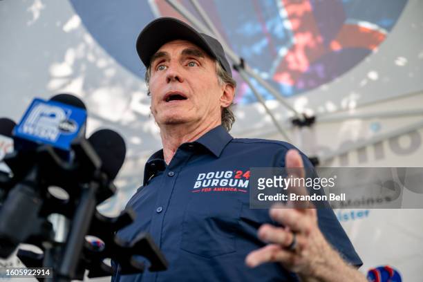 North Dakota Gov. And Republican presidential candidate Doug Burgum speaks to the press after speaking during a campaign rally at the Iowa State Fair...