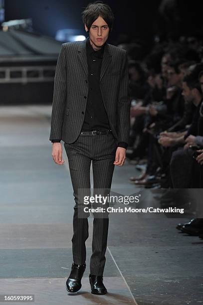Model walks the runway at the Saint Laurent Autumn Winter 2013 fashion show during Paris Menswear Fashion Week on January 20, 2013 in Paris, France.