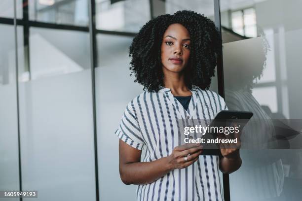 portrait of a business woman holding digital tablet - white collar worker portrait stock pictures, royalty-free photos & images