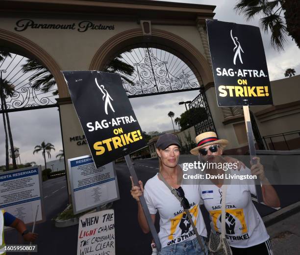 Jeri Ryan and Elizabeth Dennehy walk the picket line at Paramount Studios on August 10, 2023 in Los Angeles, California. Members of SAG-AFTRA and WGA...