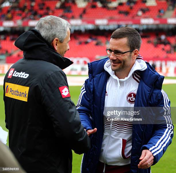 Head coaches Lucien Favre of Moenchengladbach and Michael Wiesinger of Nuernberg shake hands prior to the Bundesliga match between 1. FC Nuernberg...