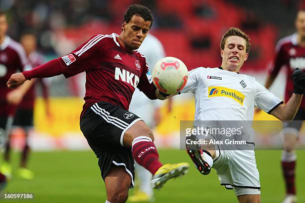 Timothy Chandler of Nuernberg is challenged by Patrick Herrmann of Moenchengladbach during the Bundesliga match between 1. FC Nuernberg and VfL...