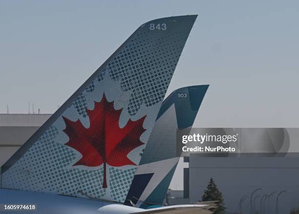 Air Canada and WestJet aircraft seen at Calgary International Airport, on August 14 in Calgary, Canada.