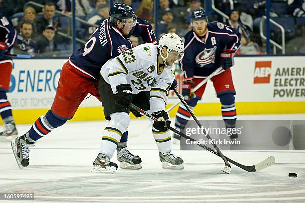 Tom Wandell of the Dallas Stars and Ryan Johansen of the Columbus Blue Jackets battle for control of a loose puck on January 28, 2013 at Nationwide...