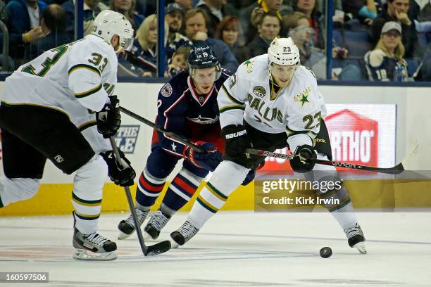 Tom Wandell of the Dallas Stars and Ryan Johansen of the Columbus Blue Jackets battle for control of a loose puck on January 28, 2013 at Nationwide...