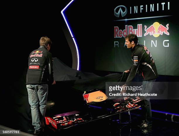 Drivers Mark Webber of Australia and Sebastian Vettel of Germany reveal the new car during the Infiniti Red Bull Racing RB9 launch on February 3,...