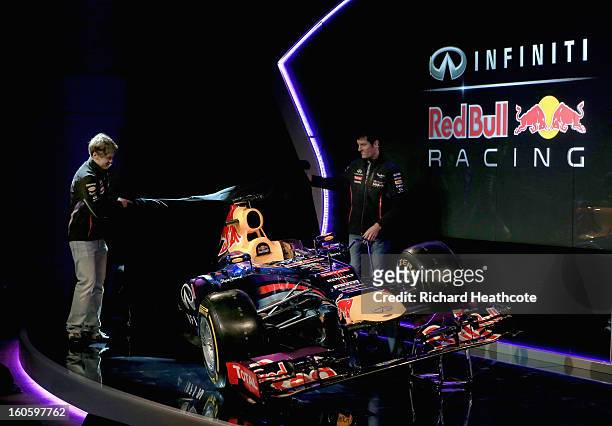 Drivers Mark Webber of Australia and Sebastian Vettel of Germany reveal the new car during the Infiniti Red Bull Racing RB9 launch on February 3,...