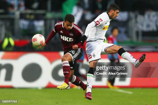 Timothy Chandler of Nuernberg is challenged by Tolga Cigerci of Moenchengladbach during the Bundesliga match between 1. FC Nuernberg and VfL Borussia...