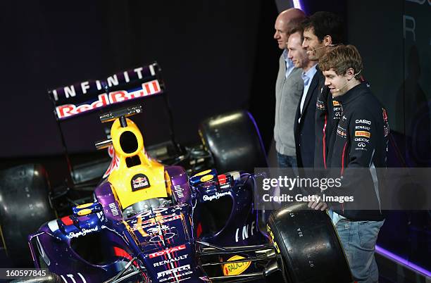 Adrian Newey, Chief Technical Officer, Christian Horner, Team Principle, Mark Webber of Australia, and Sebastian Vettel of Germany pose with the new...