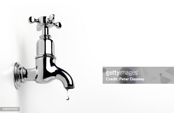 dripping tap with copy space - faucet imagens e fotografias de stock