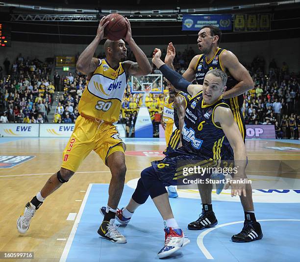 Ronnie Burrell of Oldenburg challenges for the ball with Sven Schultze of Berlin during the BBL game between EWE Baskets Oldenburg and Alba Berlin at...