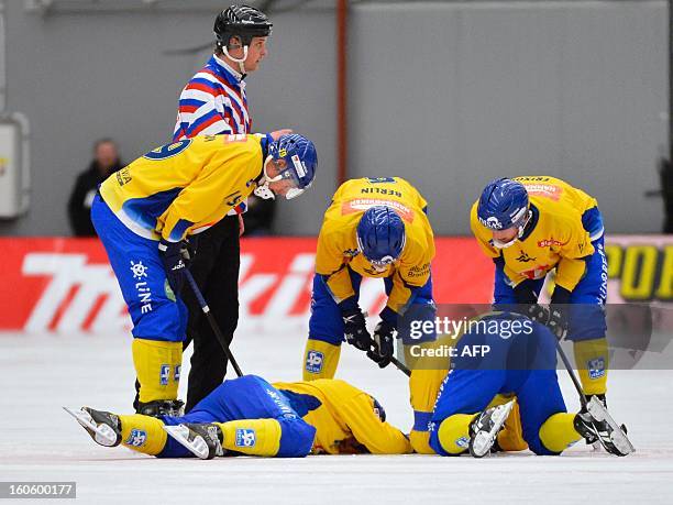 Sweden's Daniel Mossberg is injured after colliding with the referee during the Bandy World Championship final match Sweden vs Russia in Vanersborg,...