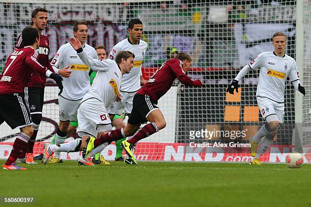 Mike Frantz of Nuernberg falls for a penalty during the Bundesliga match between 1. FC Nuernberg and VfL Borussia Moenchengladbach at Easy Credit...