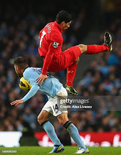Luis Suarez of Liverpool tangles with Javi Garcia of Manchester City during the Barclays Premier League match between Manchester City and Liverpool...