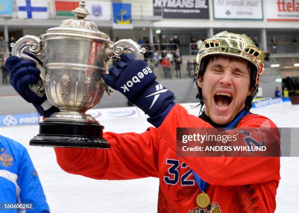 Russia's Pavel Bulatov raises the trophy as he celebrates their 4-3 victory in the Bandy World Championship final match Sweden vs Russia in...