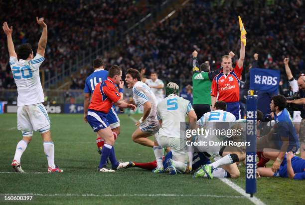 The Italian team celebrate their victory as Nigel Owens, the referee, blows the final whistle during the RBS Six Nations match between Italy and...