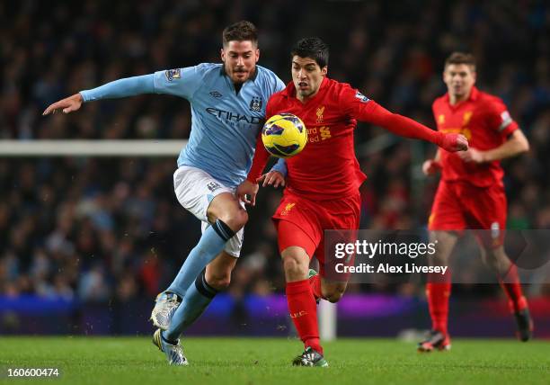 Luis Suarez of Liverpool battles for the ball with Javi Garcia of Manchester City during the Barclays Premier League match between Manchester City...