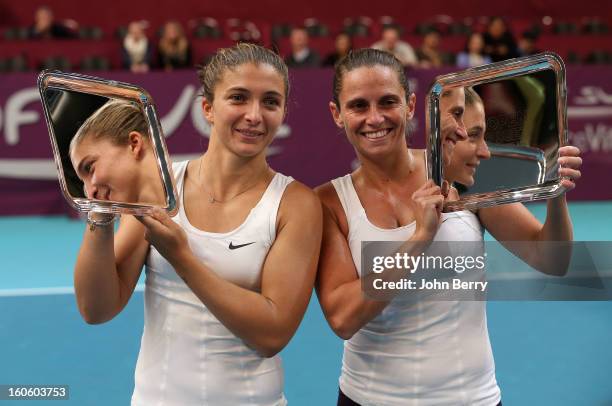 Sara Errani and Roberta Vinci of Italy hold the trophy after winning the doubles final of the Open GDG Suez 2013 at the Stade Pierre de Coubertin on...