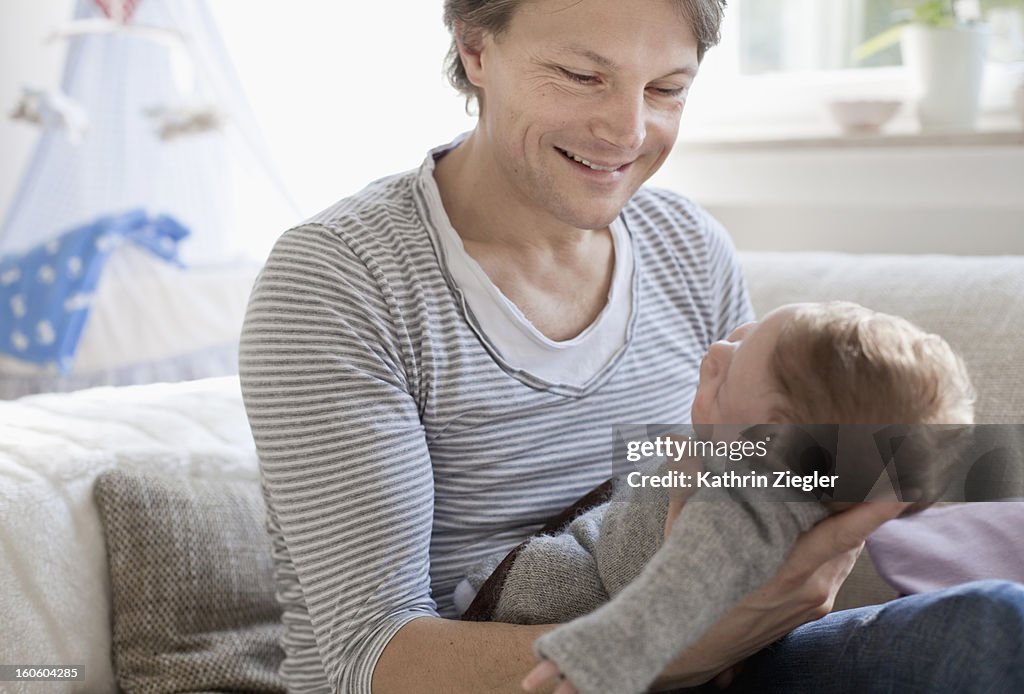 Father holding his newborn baby boy