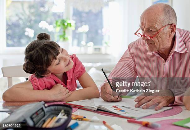 homework with grandpa - granddaughter stock pictures, royalty-free photos & images