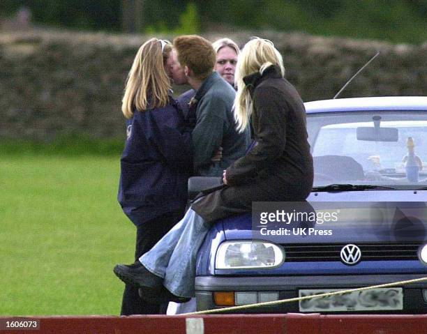 Britain''s Prince Harry kisses a friend June 9, 2001 at the Beaufort Polo Club near Tetbury in Gloucestershire, England.