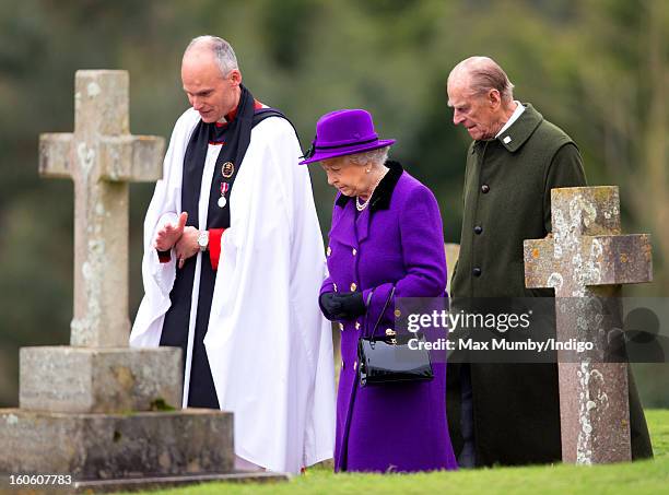 Reverend Jonathan Riviere, Queen Elizabeth II and Prince Philip, Duke of Edinburgh leave the church of St Peter and St Paul in West Newton after...