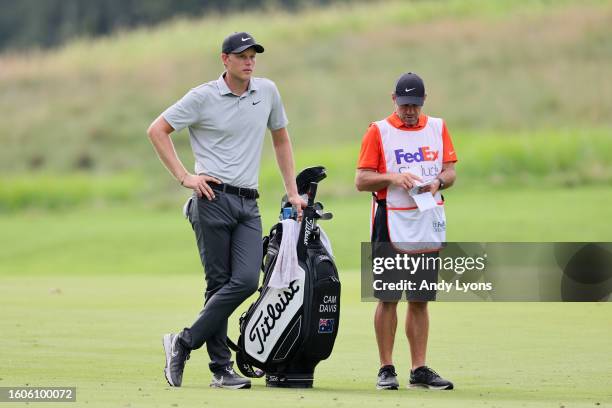 Cameron Davis of Australia and his caddie Andrew Tschudin wait to play a shot on the seventh hole during the first round of the FedEx St. Jude...