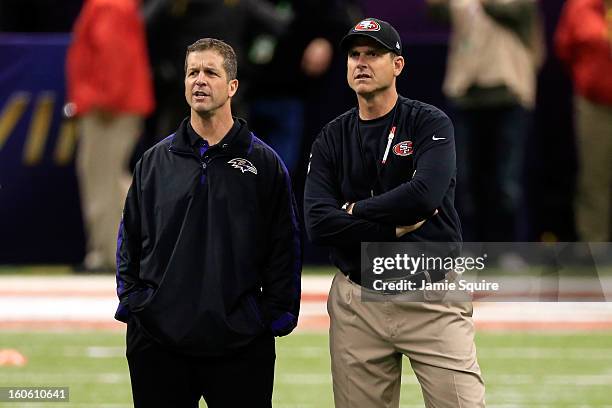 Head coach John Harbaugh of the Baltimore Ravens and head coach Jim Harbaugh of the San Francisco 49ers speak during warm ups prior to Super Bowl...