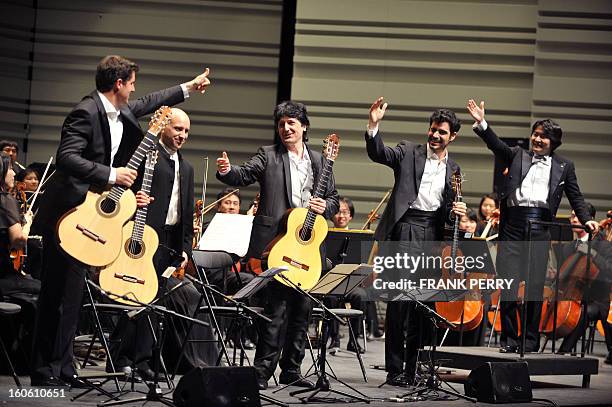 Guitarists Emmanuel Rossfelder, Fernando Espi, Juan Manuel Canizares, and Pablo Sainz Villegas salute the audience after performing with the Yokohama...