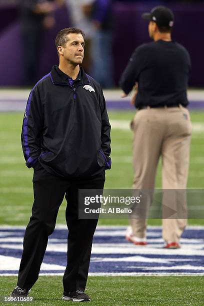 Head coach John Harbaugh of the Baltimore Ravens and head coach Jim Harbaugh of the San Francisco 49ers look on during warm ups prior to Super Bowl...