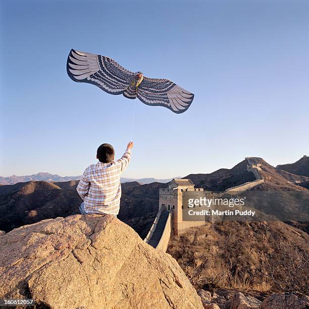 China, Beijing, the great wall, boy flying kite