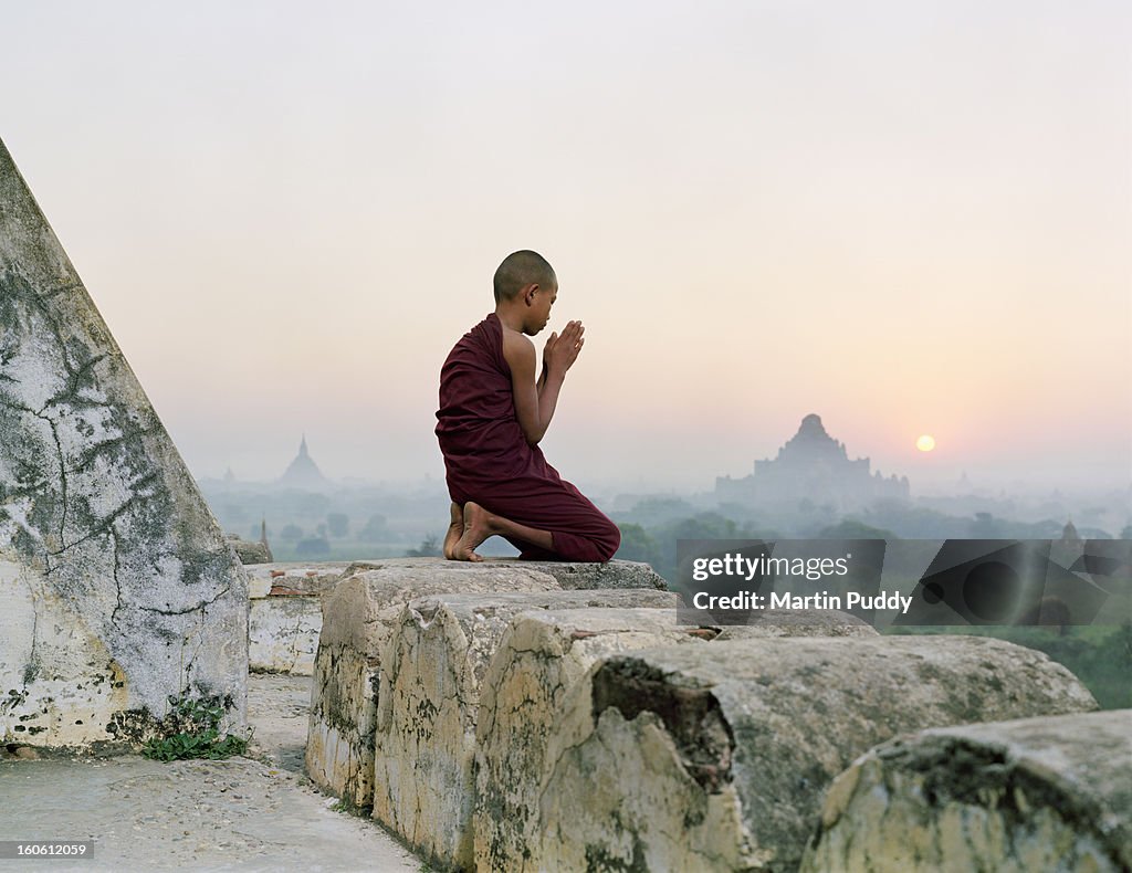 Myanmar, Bagan, Buddhist monk praying on temple