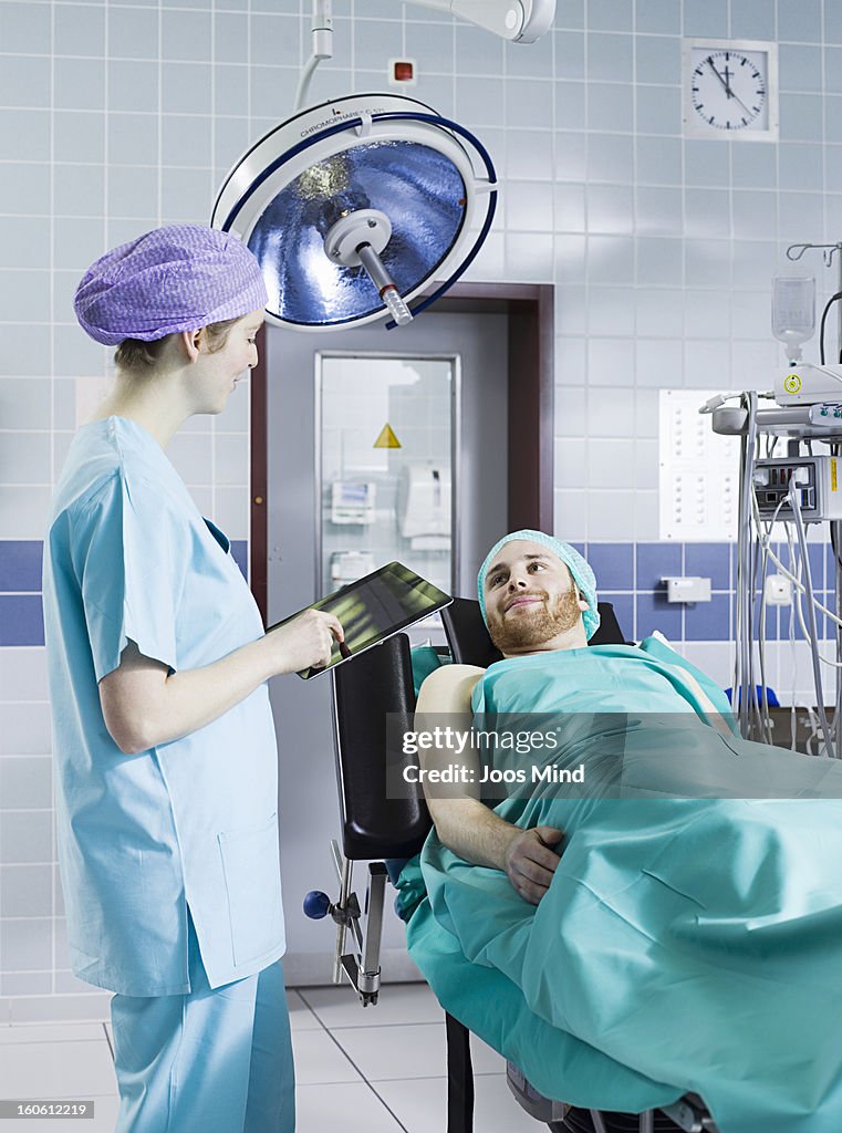 Female anaesthetist using digital tablet