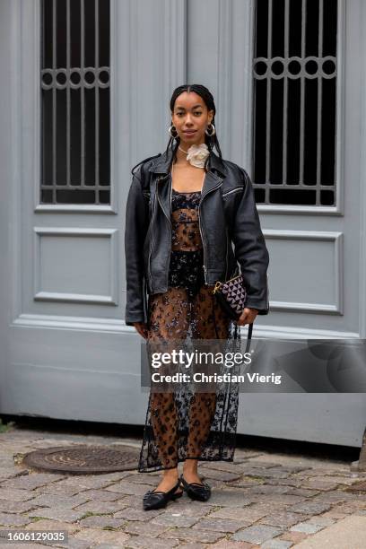 Amaka Hamelijnck wears black transparent dress, bag outside Baum und Pferdgarten during the Copenhagen Fashion Week Spring/Summer 2024 on August 09,...