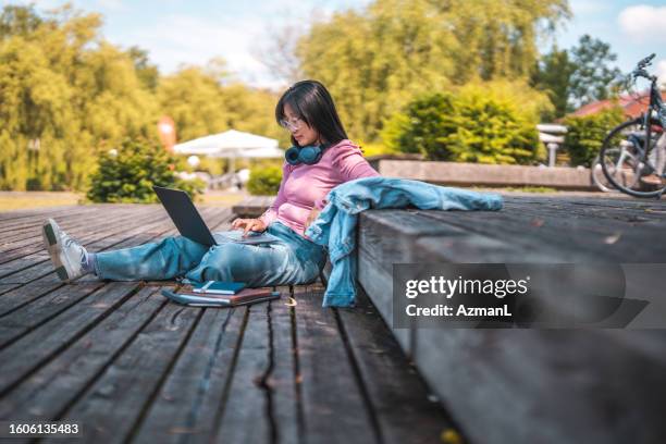 asian female freelancer  working outside - slovenia spring stock pictures, royalty-free photos & images