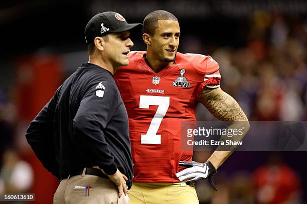 Head coach Jim Harbaugh speaks to Colin Kaepernick of the San Francisco 49ers during warm ups prior to Super Bowl XLVII against the Baltimore Ravens...